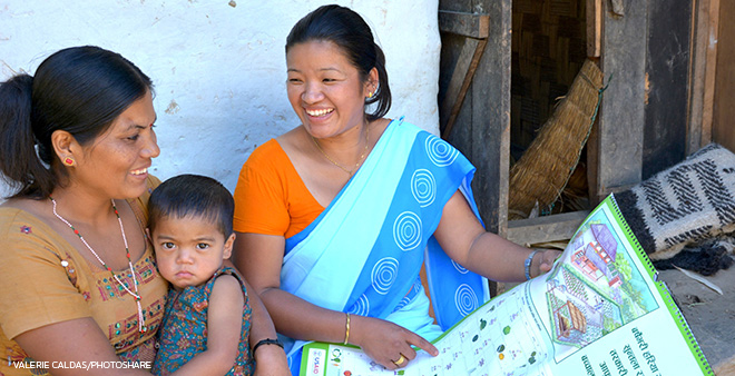 health worker teaching nutrition topics to mother with baby